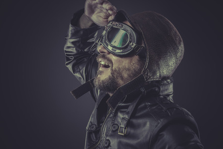 fun, pilot dressed in vintage style leather cap and gogglesの写真素材