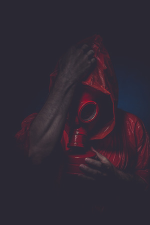 Problem, A man in a gas mask over  the smoke. black background and red colorsの写真素材
