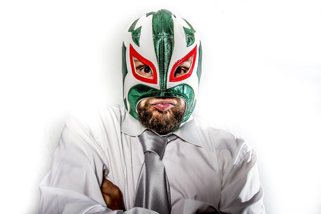 job, aggressive businessman with Mexican warrior maskの写真素材