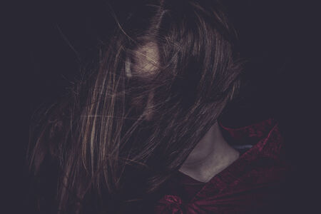 Young girl with hair flying, concept nightmaresの写真素材