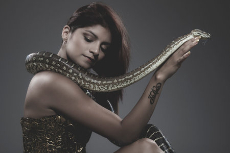 sensual beautiful latin woman with python snakeの写真素材