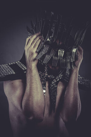 eating Man with helmet made of forks and knives, conceptの写真素材