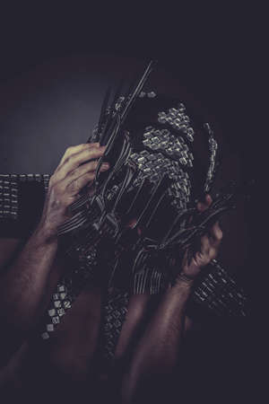 Man with helmet made of forks and knives, conceptの写真素材