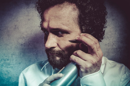 Clean, businessman with a spray, cleaning, man in white shirt with funny expressionsの写真素材