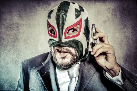 Trouble, aggressive executive suit and tie, Mexican wrestler maskの写真素材