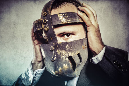 frustrated, dangerous business man with iron mask and expressionsの写真素材