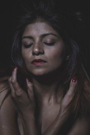 Beautiful latina woman with hair flyingの写真素材