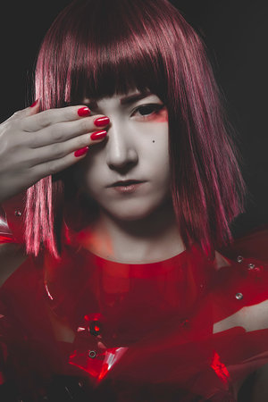 Innocence, beautiful young oriental suit made ââof red acrylicの写真素材