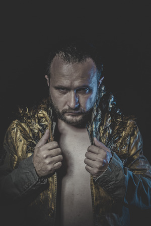 Fallen angel, man beard and suit made with golden wingsの写真素材