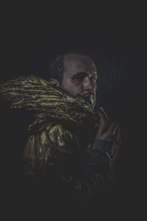 Sexy Fallen angel, man beard and suit made with golden wings