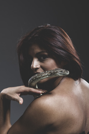 Warning, Sensual tattooed woman with big snake and iron corsetの写真素材