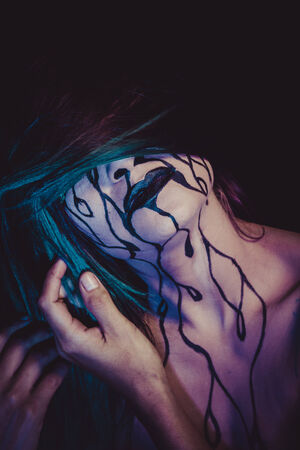 sorrow concept, crying woman with tears and makeup dark lightの写真素材