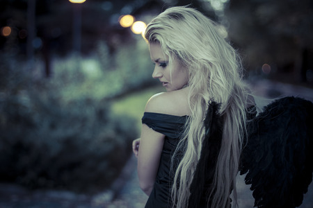 romantic scene, beautiful blond, fallen angel with black dressの写真素材