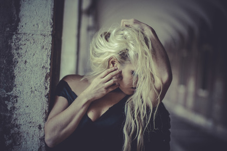 Sexy Glamour Blonde angel, young woman with black wings, autumn sceneの写真素材