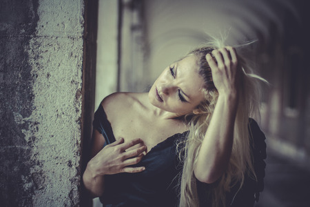 Sexy Glamour Blonde angel, young woman with black wings, autumn sceneの写真素材