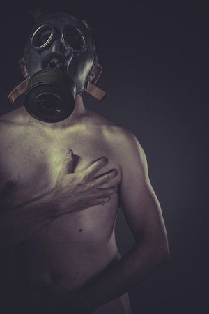 Infection, concept of risk of contamination, naked man with gas maskの写真素材