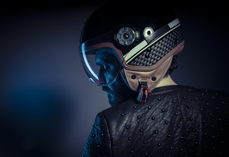 Travel, biker with motorcycle helmet and black leather jacket, metal studsの写真素材