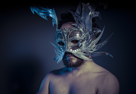 Treasure, jewels and silver. Man with mask of precious metalsの写真素材