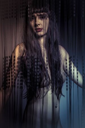 Romantic, naked girl behind curtains of black threadsの写真素材