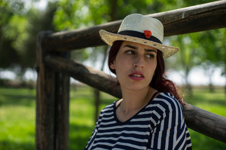 girl with straw hat in a park in spring