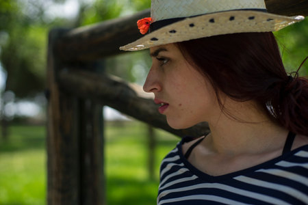 girl with straw hat in a park in springの写真素材