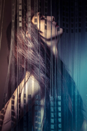 Emotional naked girl behind curtains of black threadsの写真素材