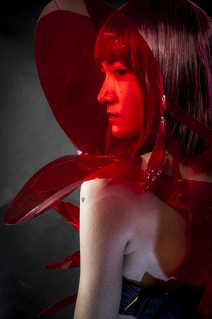 robot with red armor, beautiful young Japanese woman in a suit methacrylateの写真素材