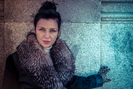 Russian woman in fur coat in a park in autumnの写真素材