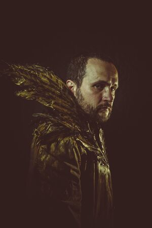 jacket attractive man with golden feathersの写真素材