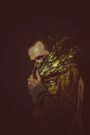 jacket attractive man with golden feathersの写真素材