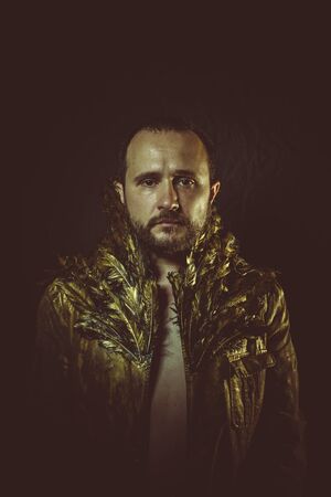 jacket attractive man with golden feathersの写真素材