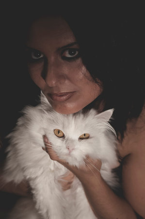 brunette woman with white Persian cat with long hairの写真素材