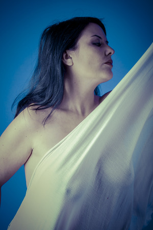 Greek muse with white veil, beautiful brunette woman with long clothの写真素材