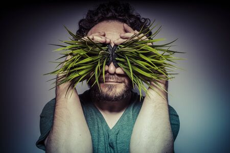 ecology concept, man with green grass in the mouthの写真素材