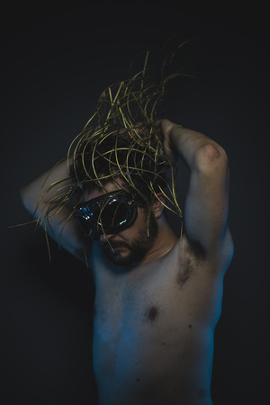 failure, depression and anxiety, naked man with a crown of thorns on his headの写真素材