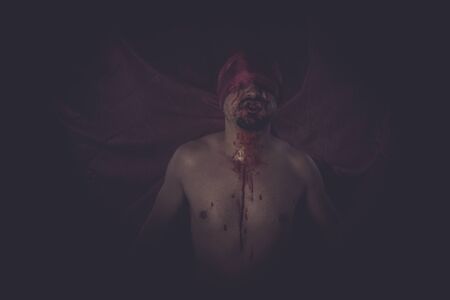 Fear, naked man on large red cloth over his eyesの写真素材
