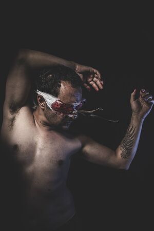 Creepy, naked man with blindfold and forksの写真素材