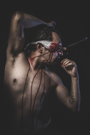 naked man with blindfold and forksの写真素材