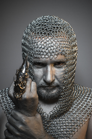 Protection, man in chain mail and leather painted silver, medieval warriorの写真素材