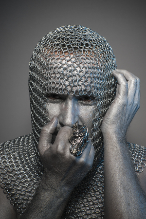 Protection, man in chain mail and leather painted silver, medieval warriorの写真素材