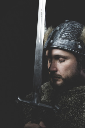War, Viking warrior with iron sword and helmet with hornsの写真素材