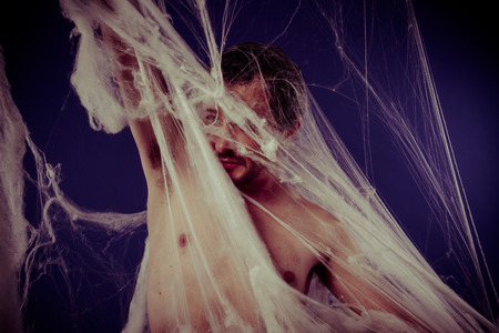 Halloween, mental disorders, man trapped in a giant spider webの写真素材