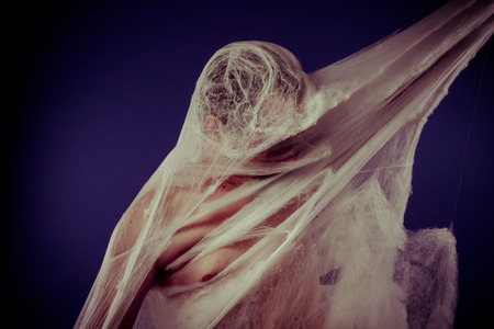 Creepy, mental disorders, man trapped in a giant spider webの写真素材