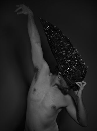 nightmare, naked man with great skull helmet and metal forksの写真素材