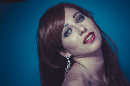 Lovely.Beautiful sexy woman with elegant long red shiny hair , hairstyle. Red-haired cutie. pretty girl with curlsの写真素材