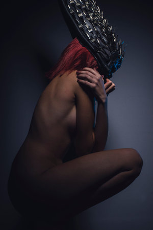 alien woman naked helmeted skull and metal forksの写真素材