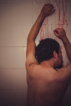 fear naked man with red gas mask, blood, despair and suicideの写真素材