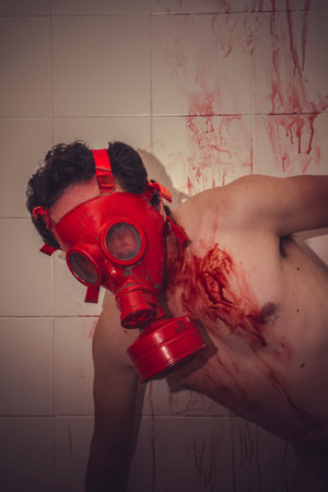 sad naked man with red gas mask, blood, despair and suicideの写真素材