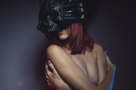 sensual alien woman naked helmeted skull and metal forksの写真素材