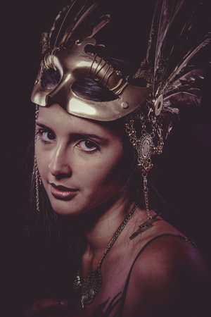 Shiny Sensual young woman with golden mask jewelry